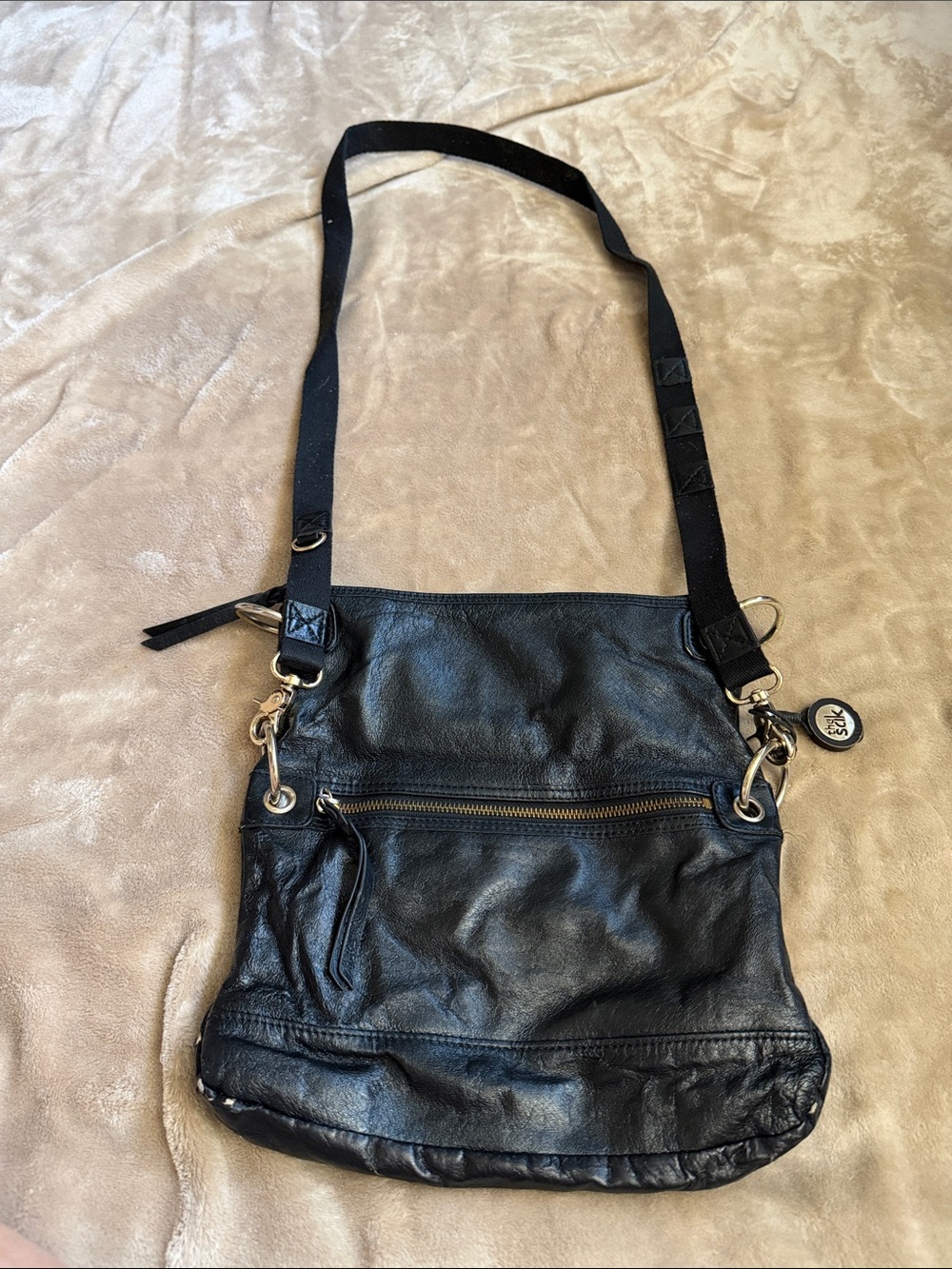 The Sak Black Leather Crossbody with Front Zip and Removable Charm